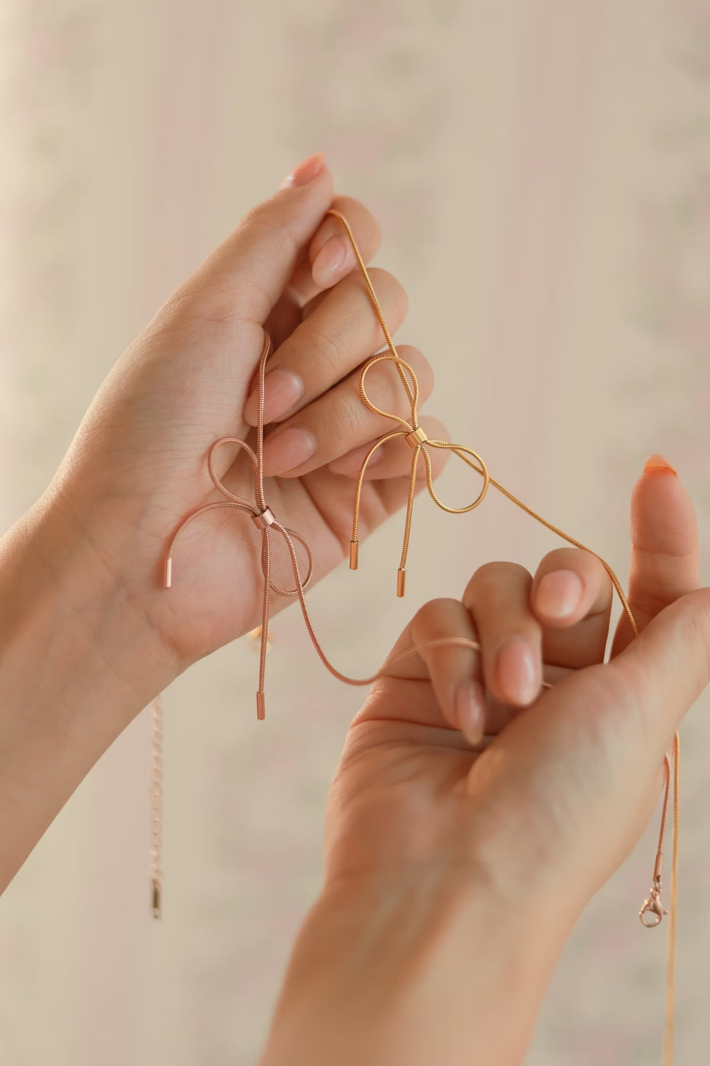 bow necklace in pink rose gold and gold finish 