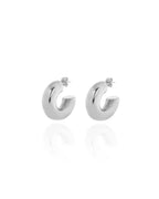 Silver chunky hoop earrings with a glossy finish, designed as bold statement accessories