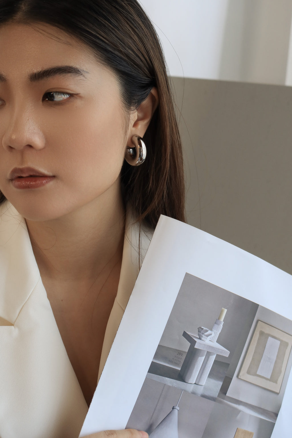 Silver chunky hoop earrings with a glossy finish, designed as bold statement accessories